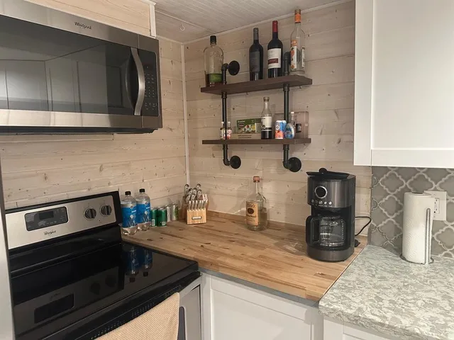 a kitchen with stainless steel appliances granite countertop a sink and a stove