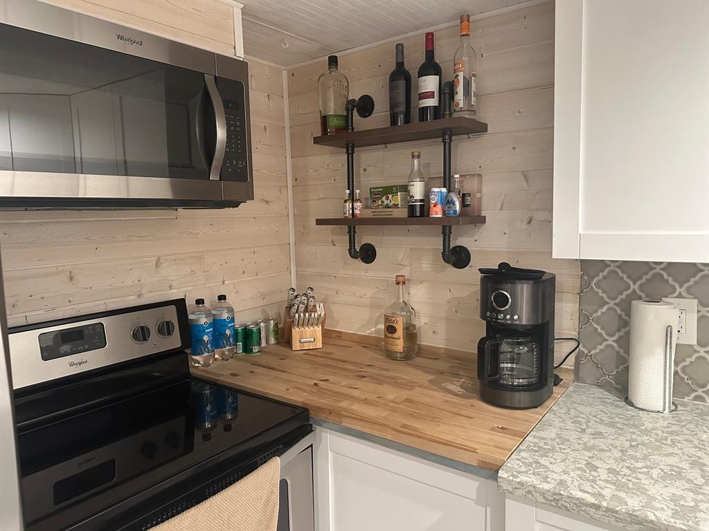 1009 North Ocean Boulevard, Unit 407 Pompano Beach, FL 33062 - Photo 6 of 35 a kitchen with stainless steel appliances granite countertop a sink and a stove