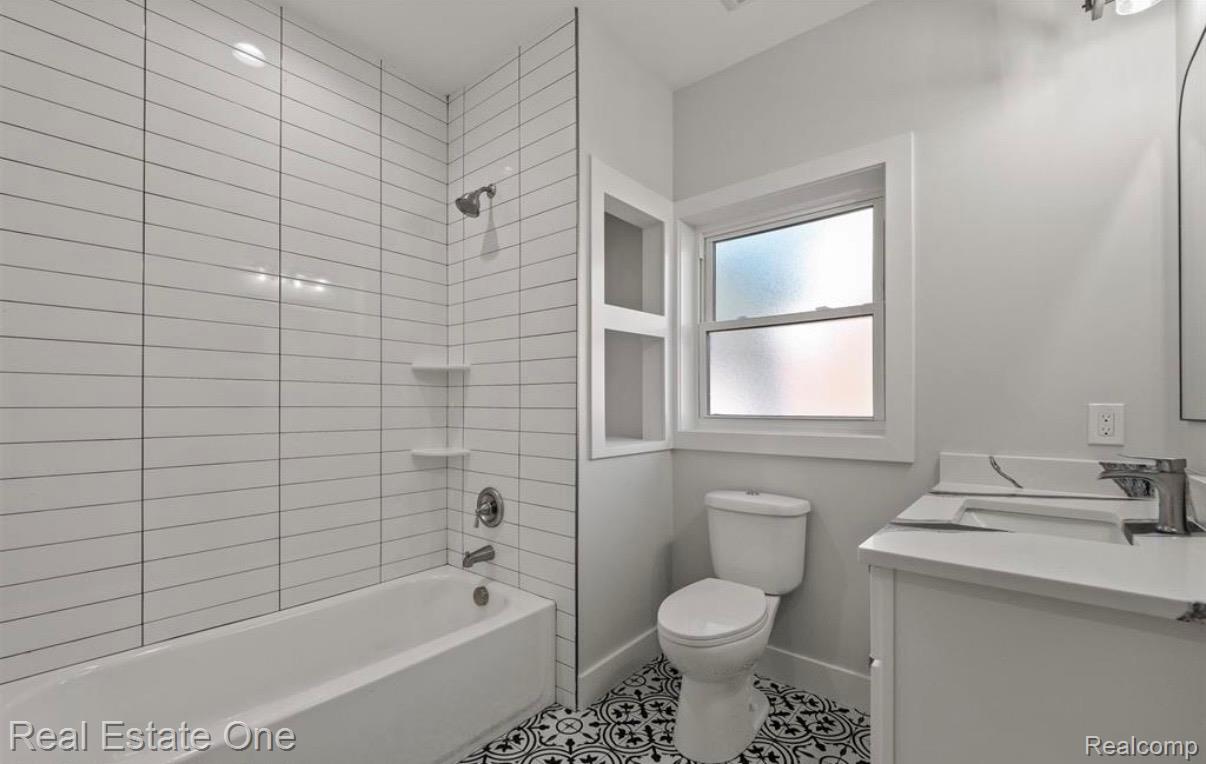 5636 Paris Street Sterling Heights, MI 48310 - Photo 23 of 37 Full bathroom featuring tub / shower combination, vanity, and light tile patterned floors