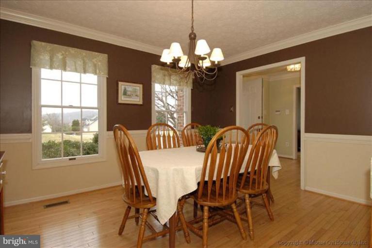 913 Metfield Road Towson, MD 21286 - Photo 3 of 26 a view of a dining room with furniture a chandelier and wooden floor