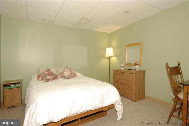913 Metfield Road Towson, MD 21286 - Photo 22 of 26 a bedroom with a bed and wooden floor