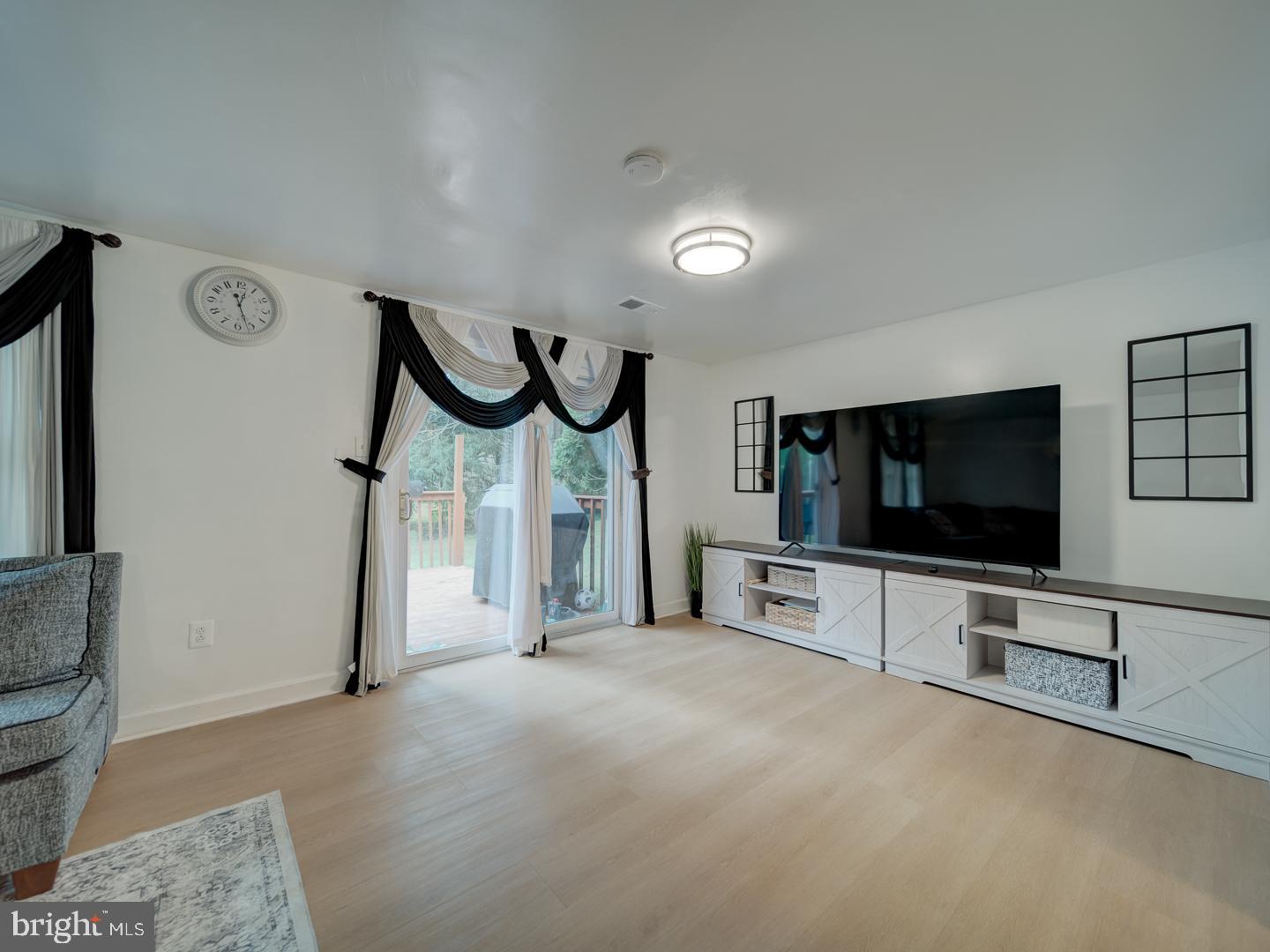 10397 Blue Arrow Court Columbia, MD 21044 - Photo 29 of 43 a view of a livingroom with furniture and a flat screen tv