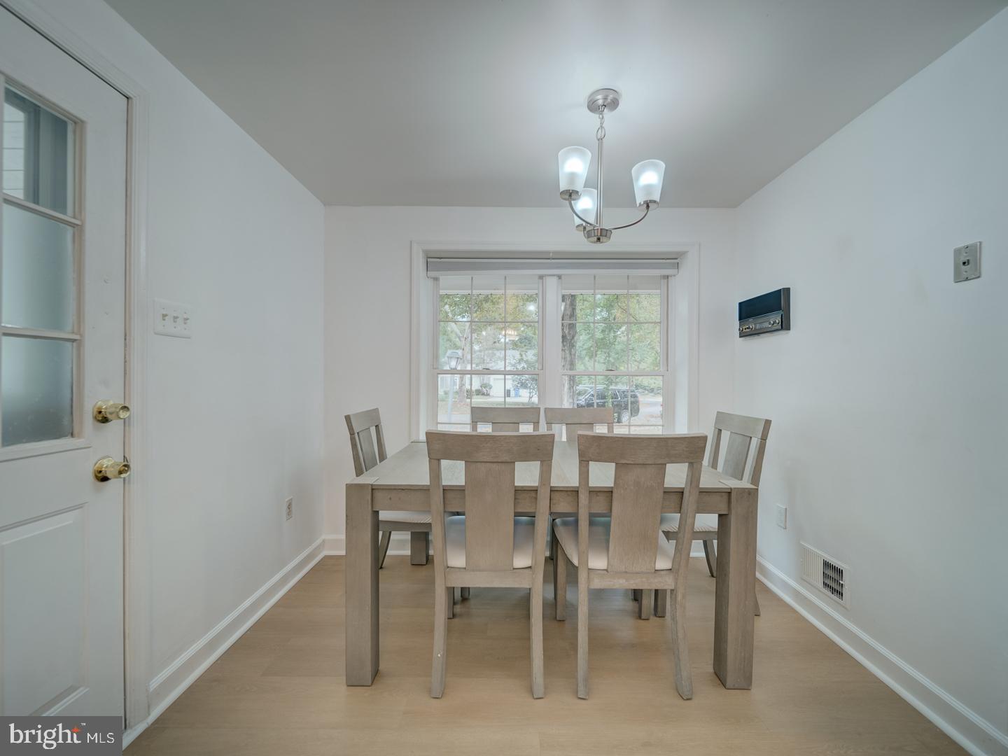 10397 Blue Arrow Court Columbia, MD 21044 - Photo 31 of 43 a view of a dining room with furniture a chandelier and window