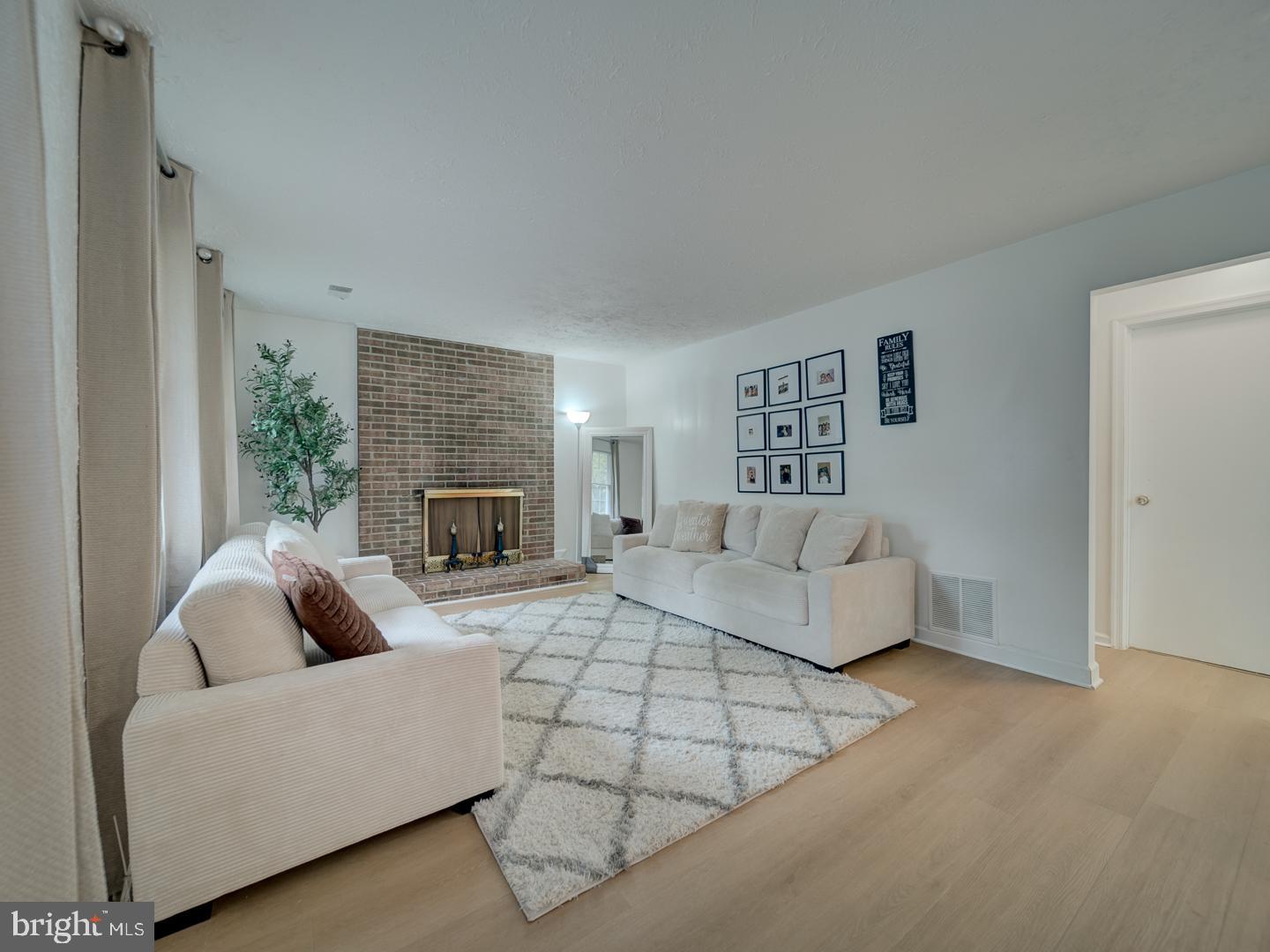 10397 Blue Arrow Court Columbia, MD 21044 - Photo 4 of 43 a living room with furniture and a fireplace