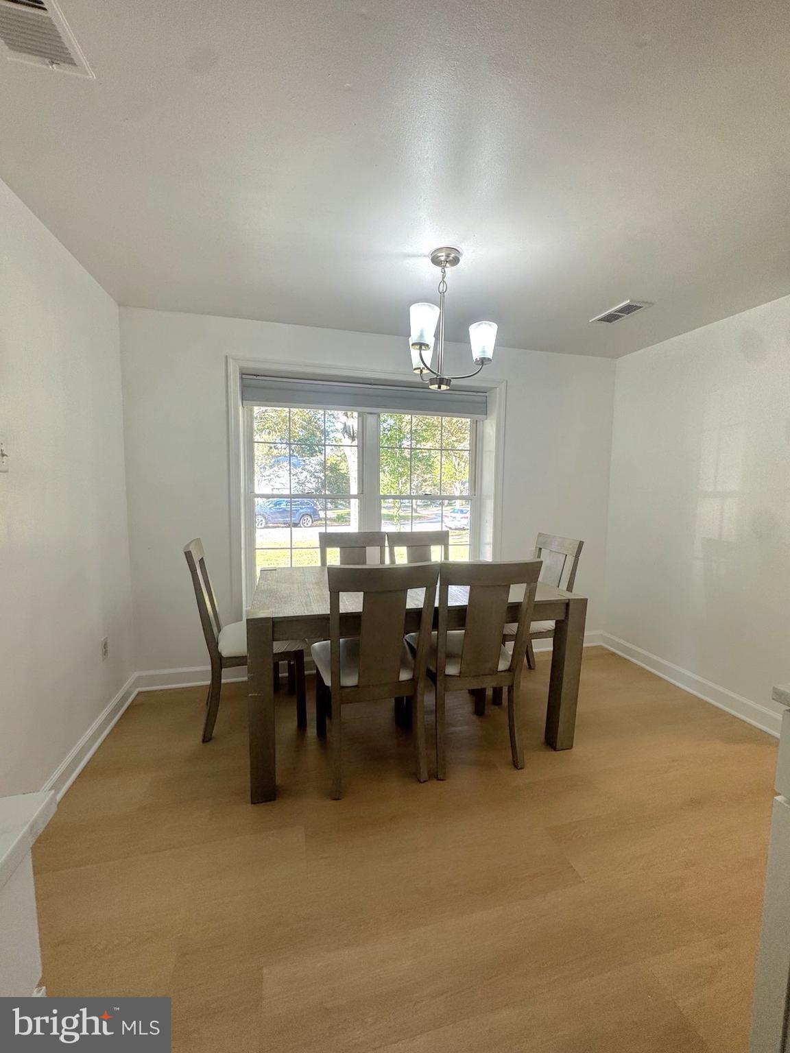 10397 Blue Arrow Court Columbia, MD 21044 - Photo 42 of 43 a view of a dining room with furniture and chandelier