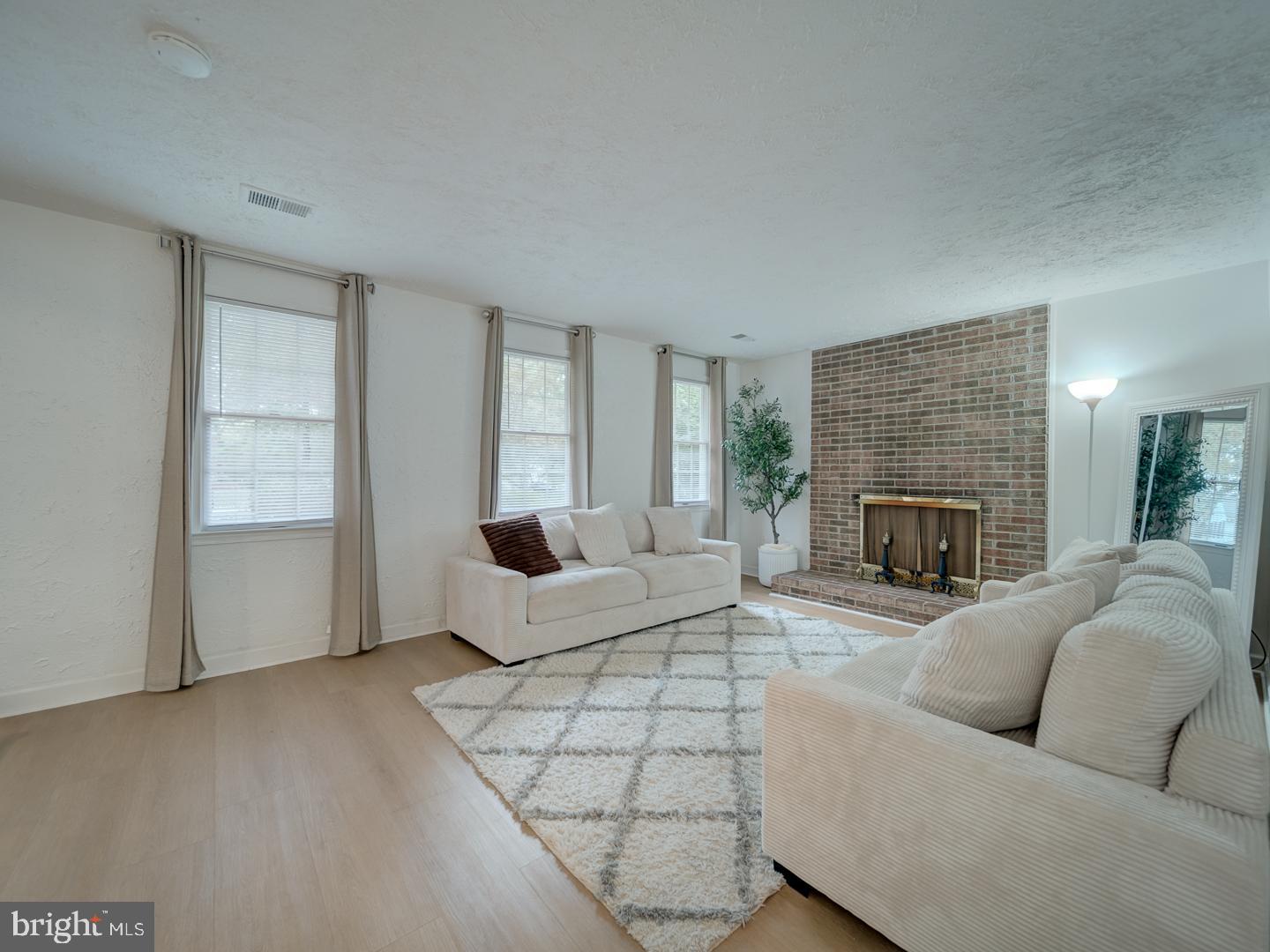 10397 Blue Arrow Court Columbia, MD 21044 - Photo 5 of 43 a living room with furniture and a fireplace