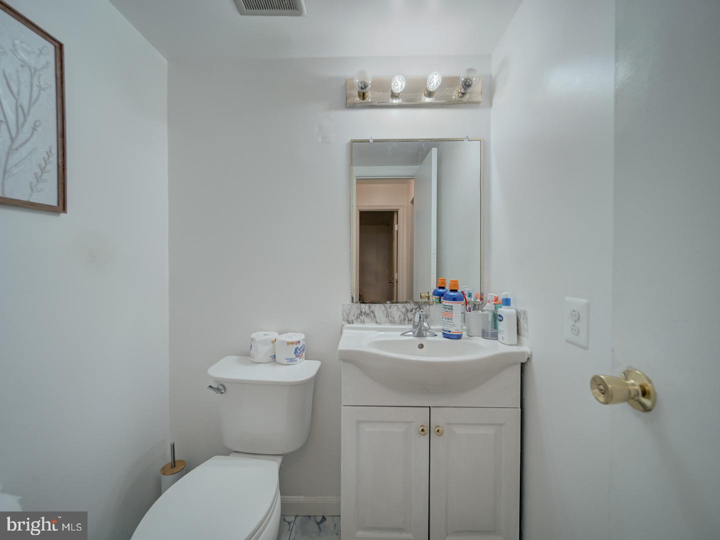 10397 Blue Arrow Court Columbia, MD 21044 - Photo 7 of 43 a bathroom with a toilet sink and mirror