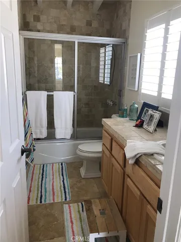 a bathroom with a sink toilet and window