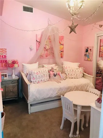 a bedroom with a bed and a dresser