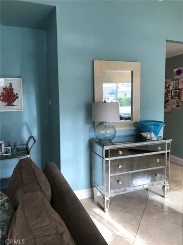 a bedroom with a bed and a dresser next to it