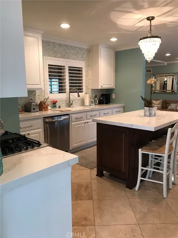 a kitchen with a sink a stove a dining table and chairs