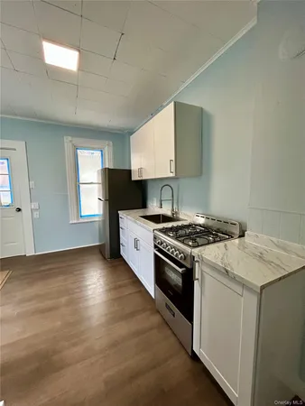 a kitchen with a refrigerator and a stove top oven