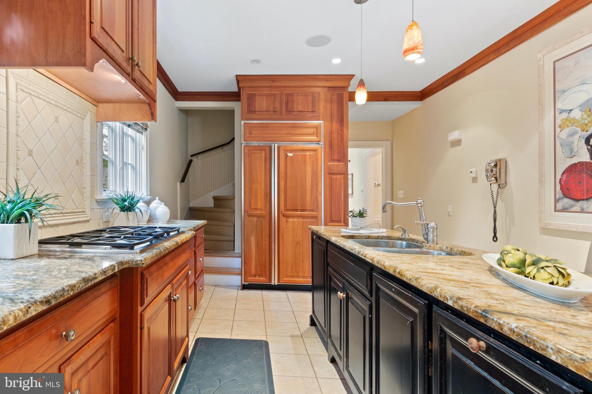 512 Dorset Road Devon, PA 19333 - Photo 28 of 48 a kitchen with stainless steel appliances granite countertop a sink a stove and a wooden cabinets