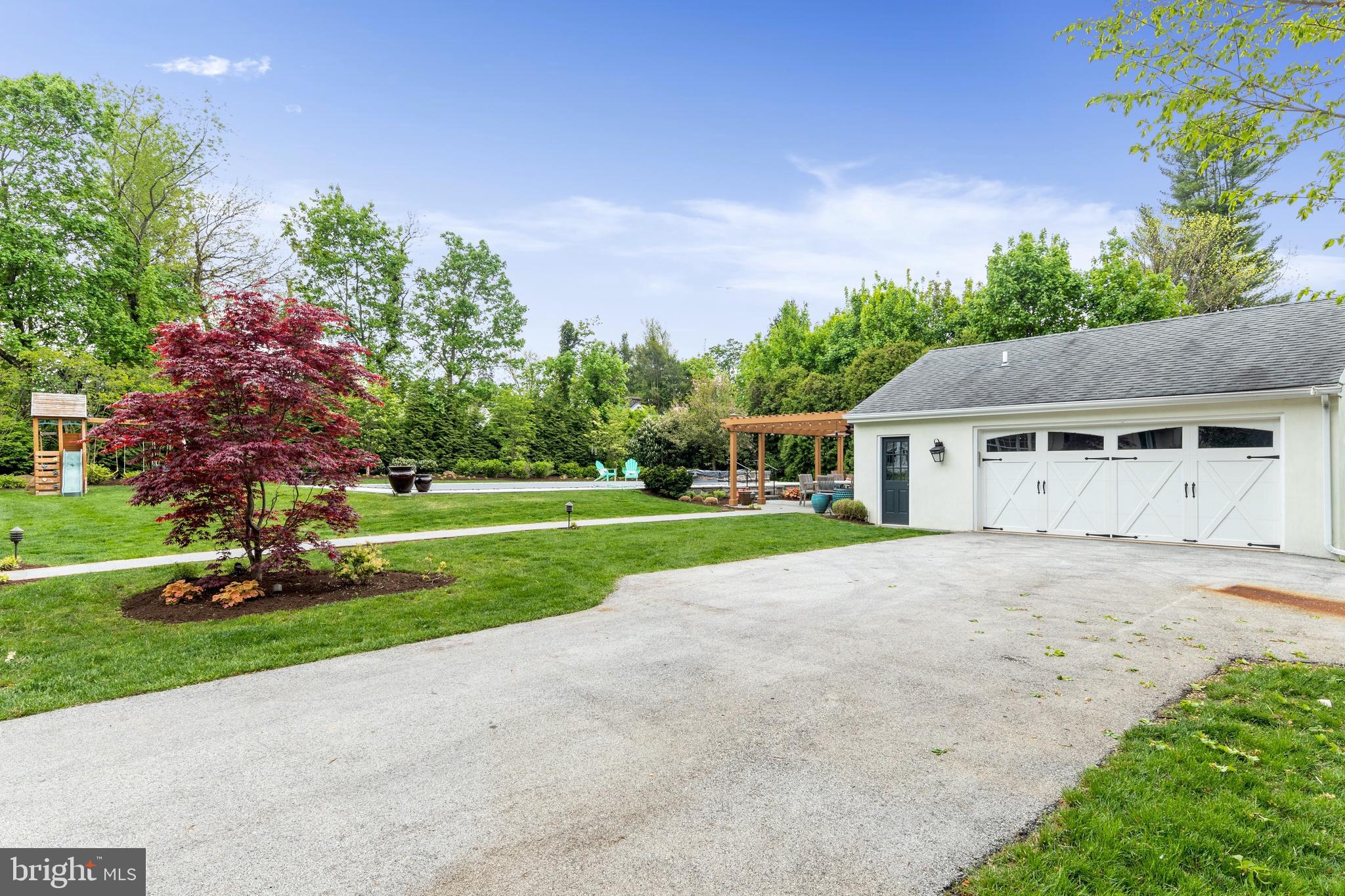 512 Dorset Road Devon, PA 19333 - Photo 10 of 48 a front view of a house with a yard and trees
