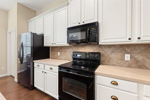 a kitchen with a table chairs sink and refrigerator