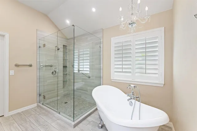 a bathroom with a shower a sink and mirror