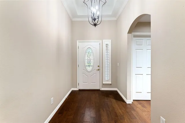 a view of a livingroom with wooden floor and a window