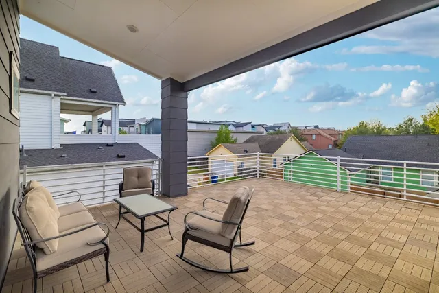 a view of a porch with furniture and a yard