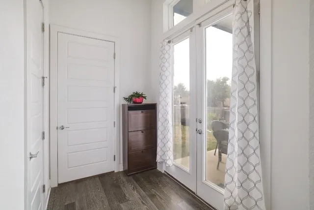 a view of a bathroom with a glass door shower and a window