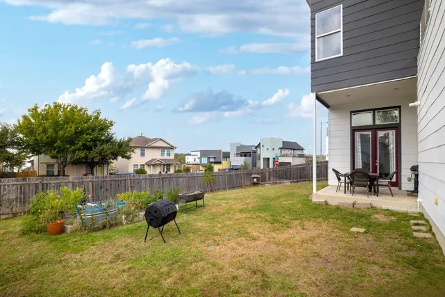 a view of a swimming pool with lawn chairs and a fire pit