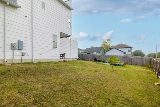a view of a patio with table and chairs under an umbrella