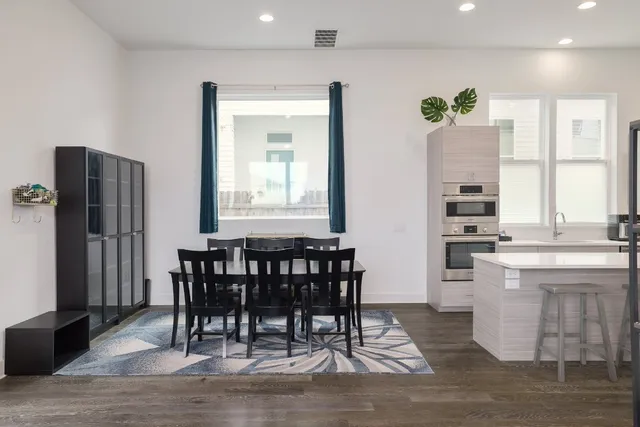 a view of a a dining room with furniture window and wooden floor