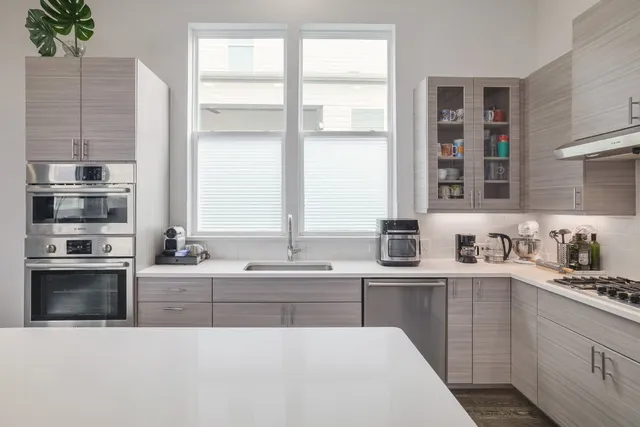 a kitchen with a sink stove and cabinets