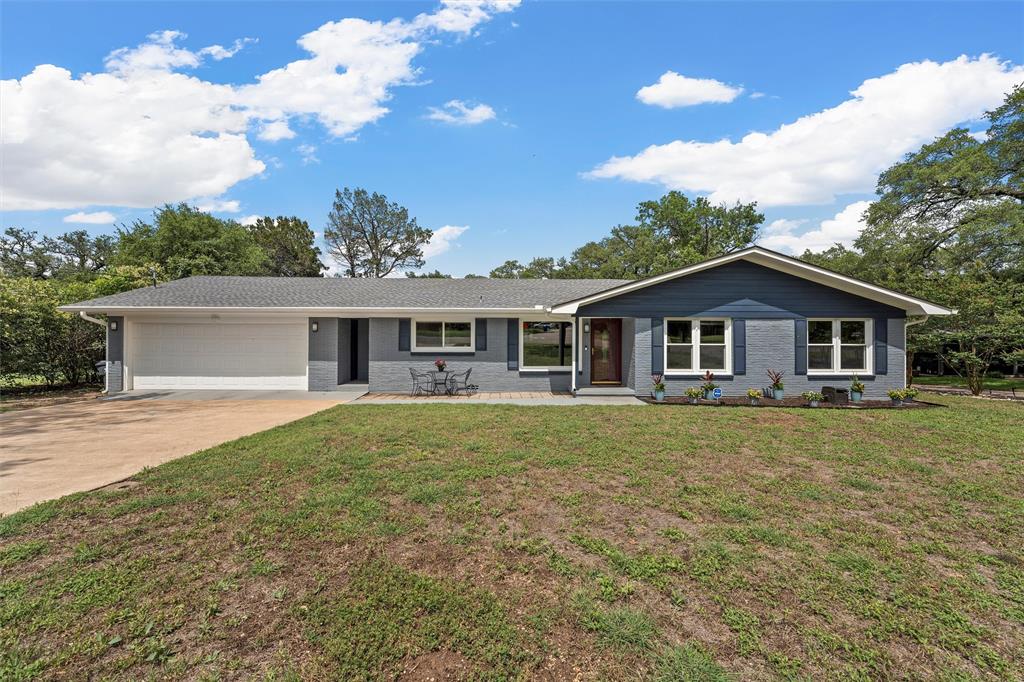 3917 North 31st Street Waco, TX 76708 - Photo 1 of 1 Ranch-style home featuring a garage, concrete driveway, a front lawn, and brick siding