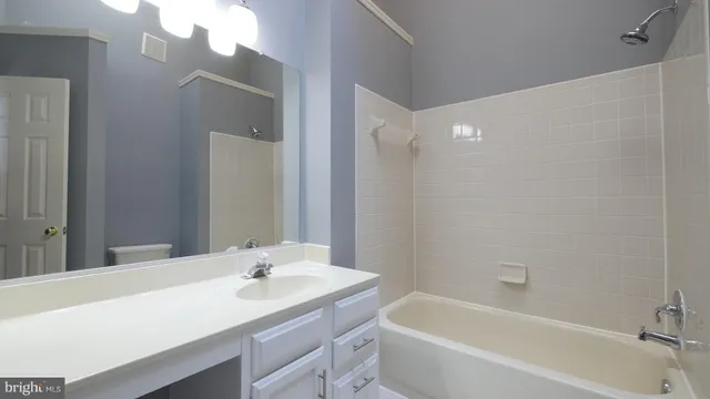a bathroom with a sink a mirror and a shower