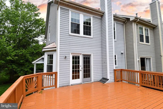 a view of a balcony with wooden floor and fence
