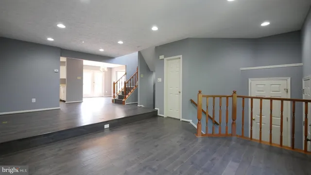 a view of a room with wooden floor