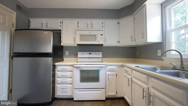 a view of an entryway with wooden floor and stairs