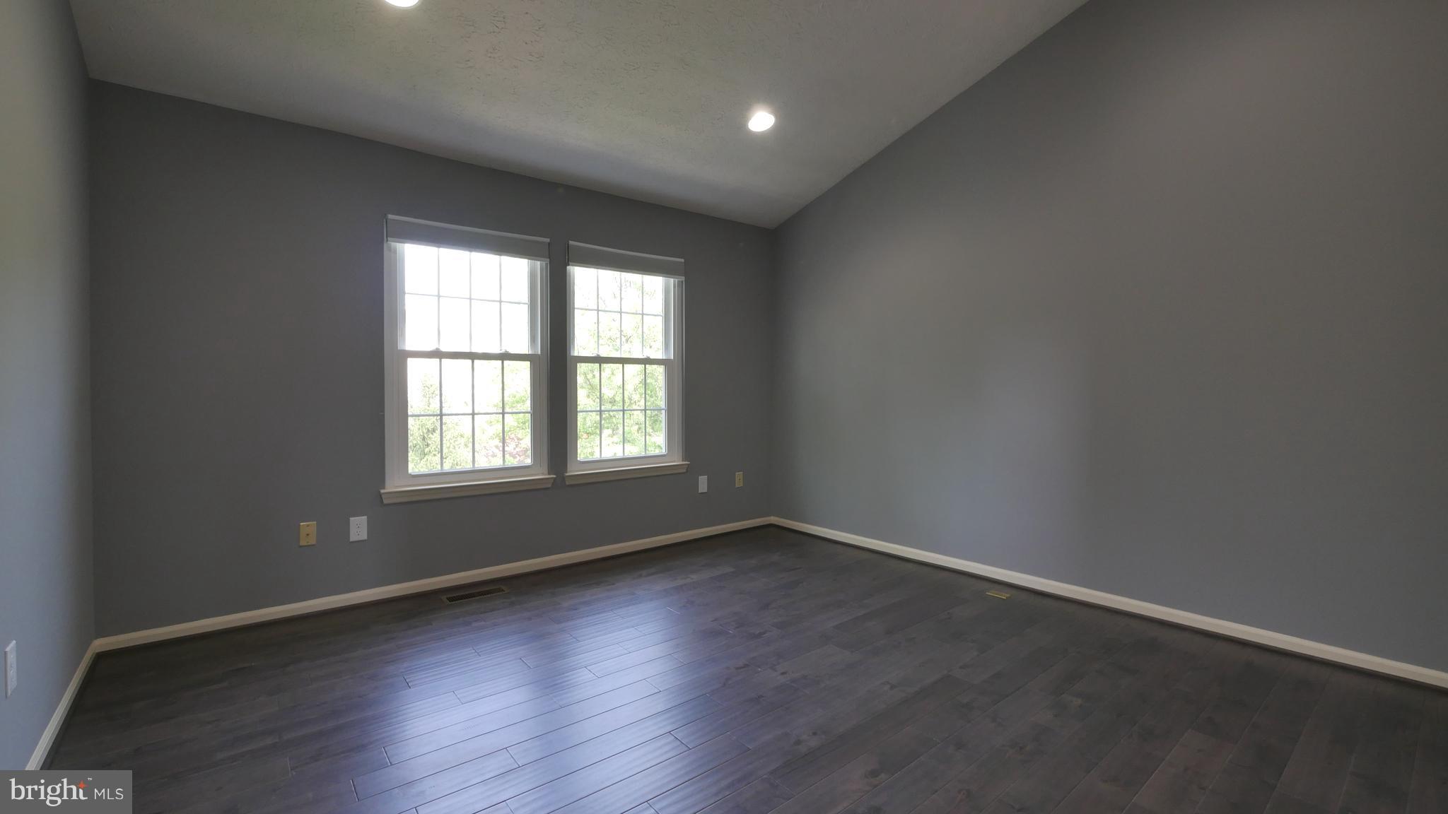 15 Beacon Hill Way Gaithersburg, MD 20878 - Photo 8 of 16 an empty room with wooden floor and windows