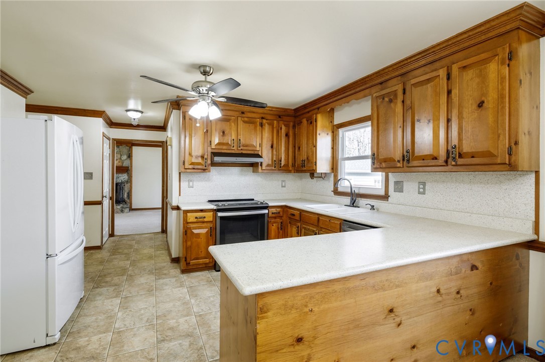 10400 Hamlin Drive Chester, VA 23831 - Photo 22 of 46 a kitchen with stainless steel appliances granite countertop a sink a stove and refrigerator