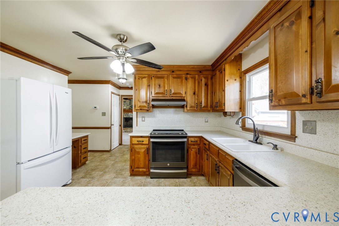 10400 Hamlin Drive Chester, VA 23831 - Photo 23 of 46 a kitchen with stainless steel appliances granite countertop a stove a sink and a refrigerator
