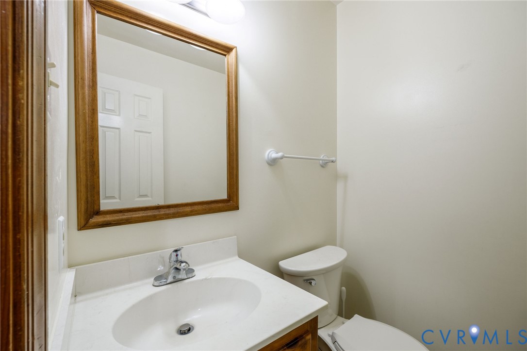 10400 Hamlin Drive Chester, VA 23831 - Photo 26 of 46 a bathroom with a sink a toilet and a mirror