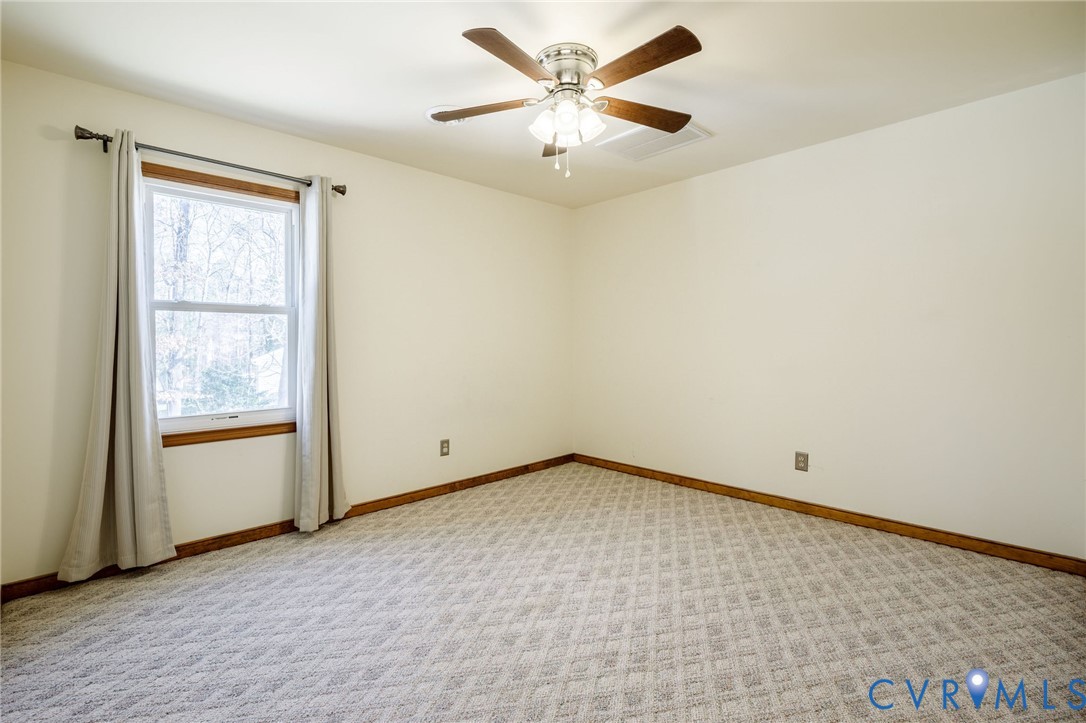 10400 Hamlin Drive Chester, VA 23831 - Photo 30 of 46 an empty room with a window and a fan