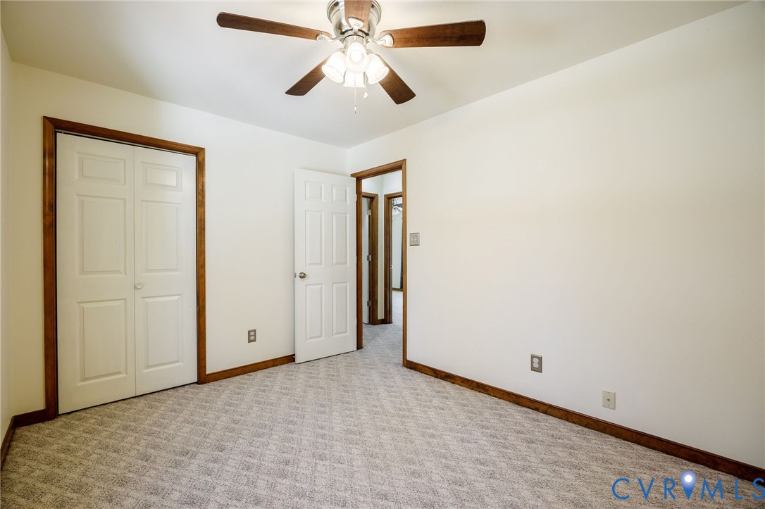 10400 Hamlin Drive Chester, VA 23831 - Photo 33 of 46 an empty room with closet and a chandelier fan