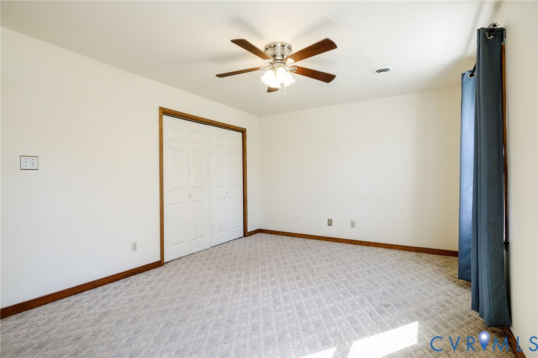 10400 Hamlin Drive Chester, VA 23831 - Photo 37 of 46 an empty room with closet and ceiling fan