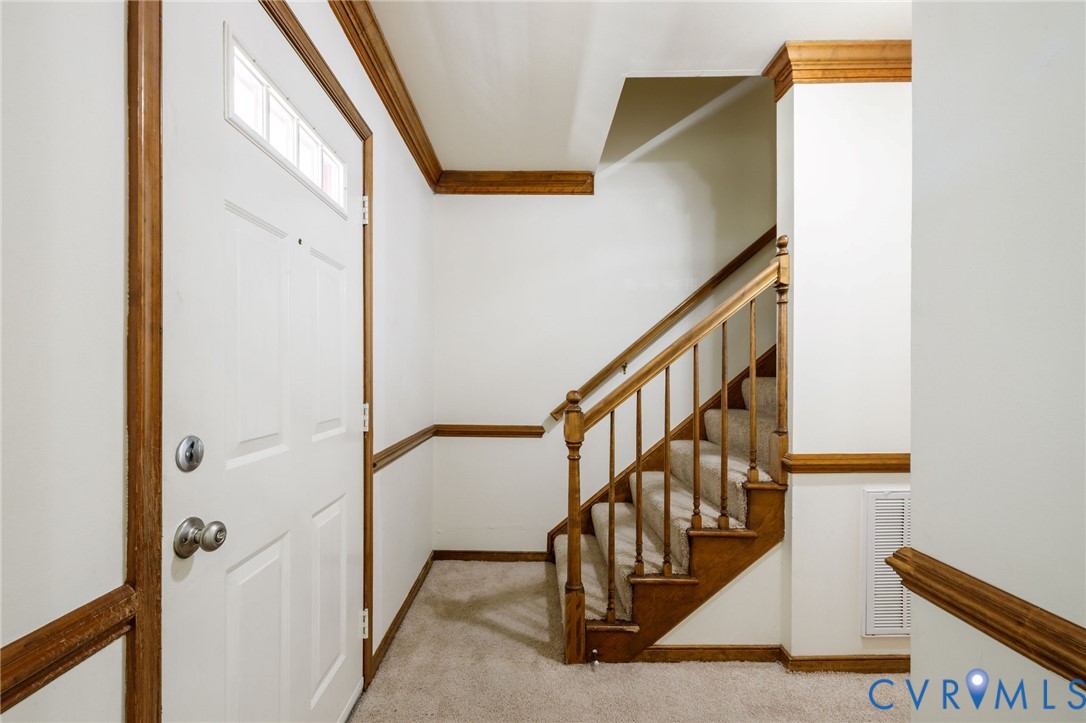 10400 Hamlin Drive Chester, VA 23831 - Photo 6 of 46 a view of staircase with lots of frames on wall and a window