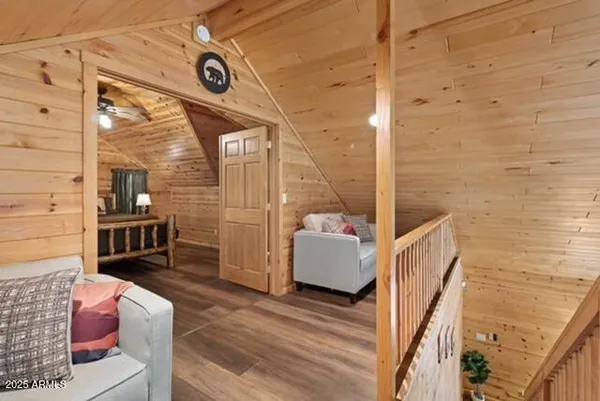 a dining room with furniture a chandelier and wooden floor