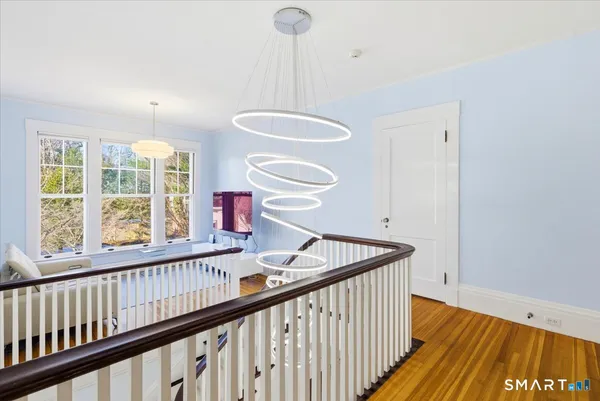 a view of a hallway with furniture and window