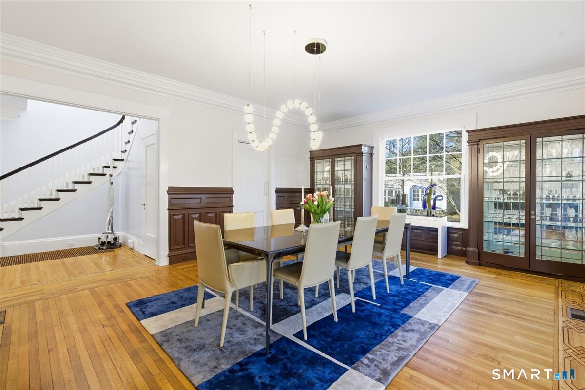 144 Edgehill Road Hamden, CT 06517 - Photo 12 of 42 a view of a dining room with furniture a chandelier and wooden floor