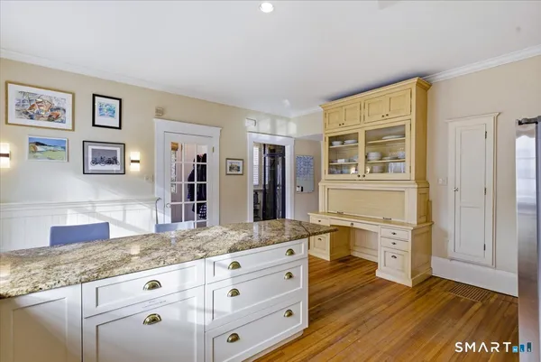 a bathroom with a granite countertop sink toilet a mirror and shower