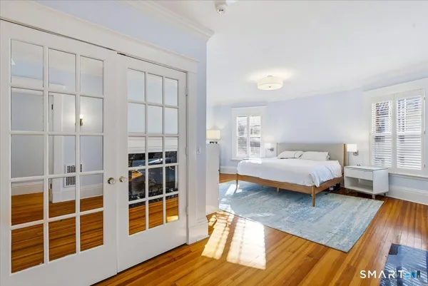 a bedroom with furniture and a window