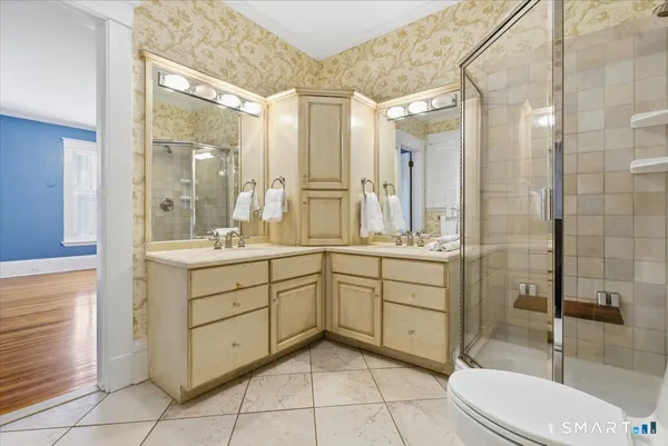 a bathroom with a sink a toilet and shower