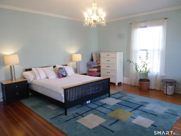 a bedroom with a bed and a table