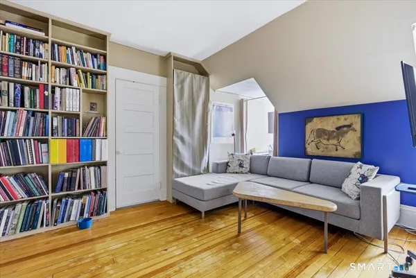 a living room with furniture and a book shelf