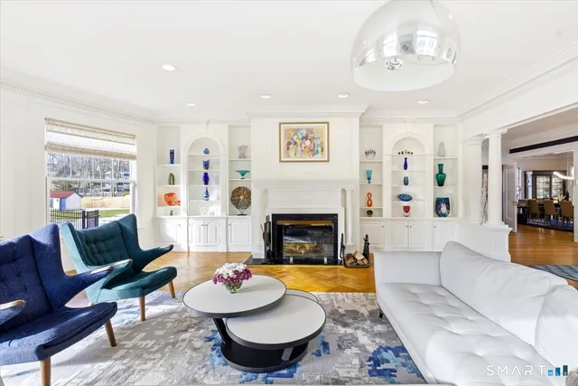 a living room with furniture piano and a rug