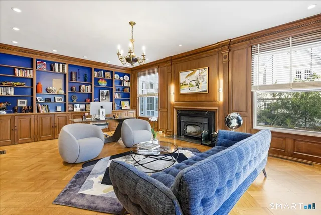 a dining room with wooden floor and large windows
